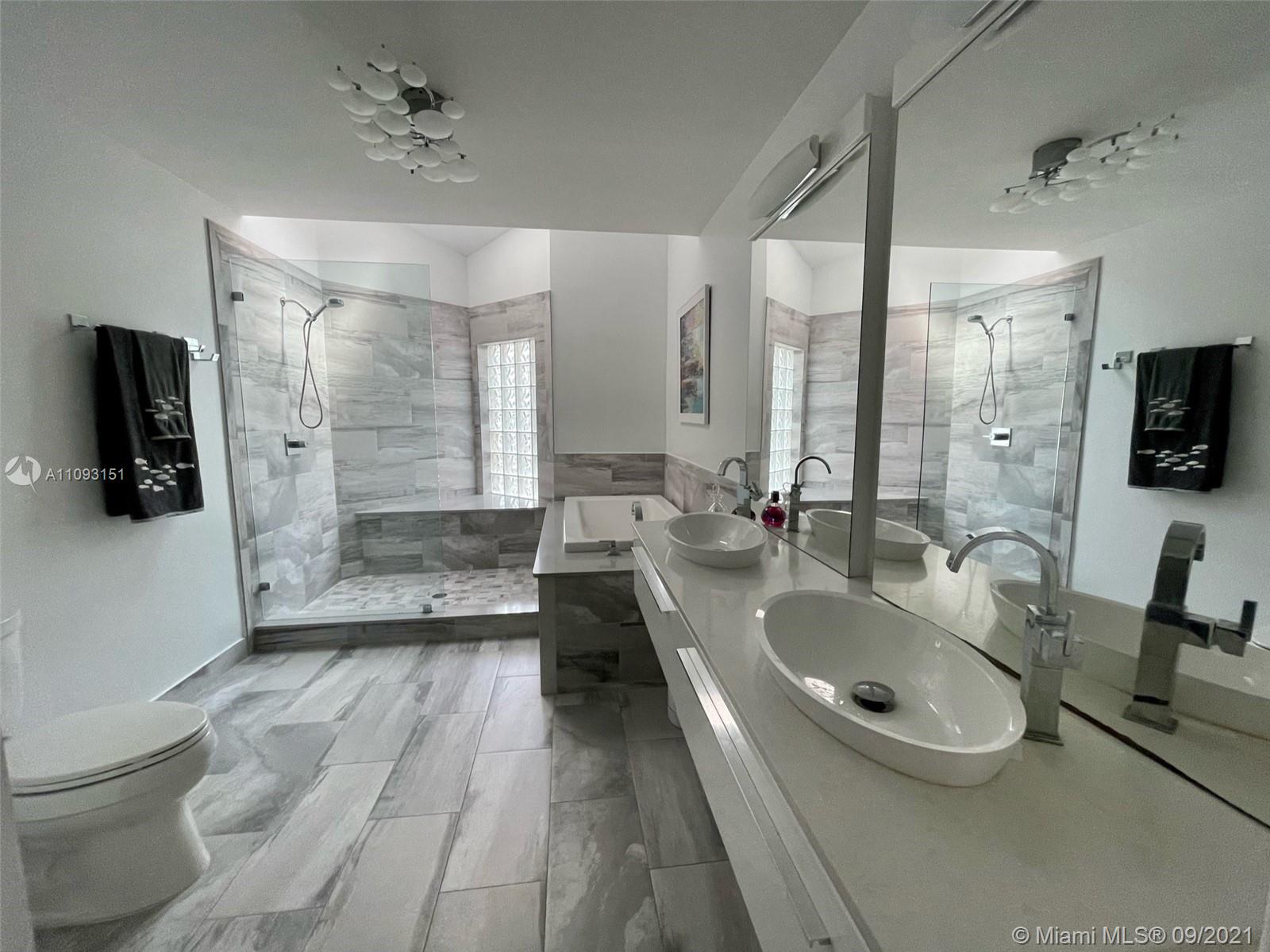 19620 Planters Point Drive Boca Raton, FL 33434 - Photo 16 of 21 a bathroom with a sink a toilet and mirror