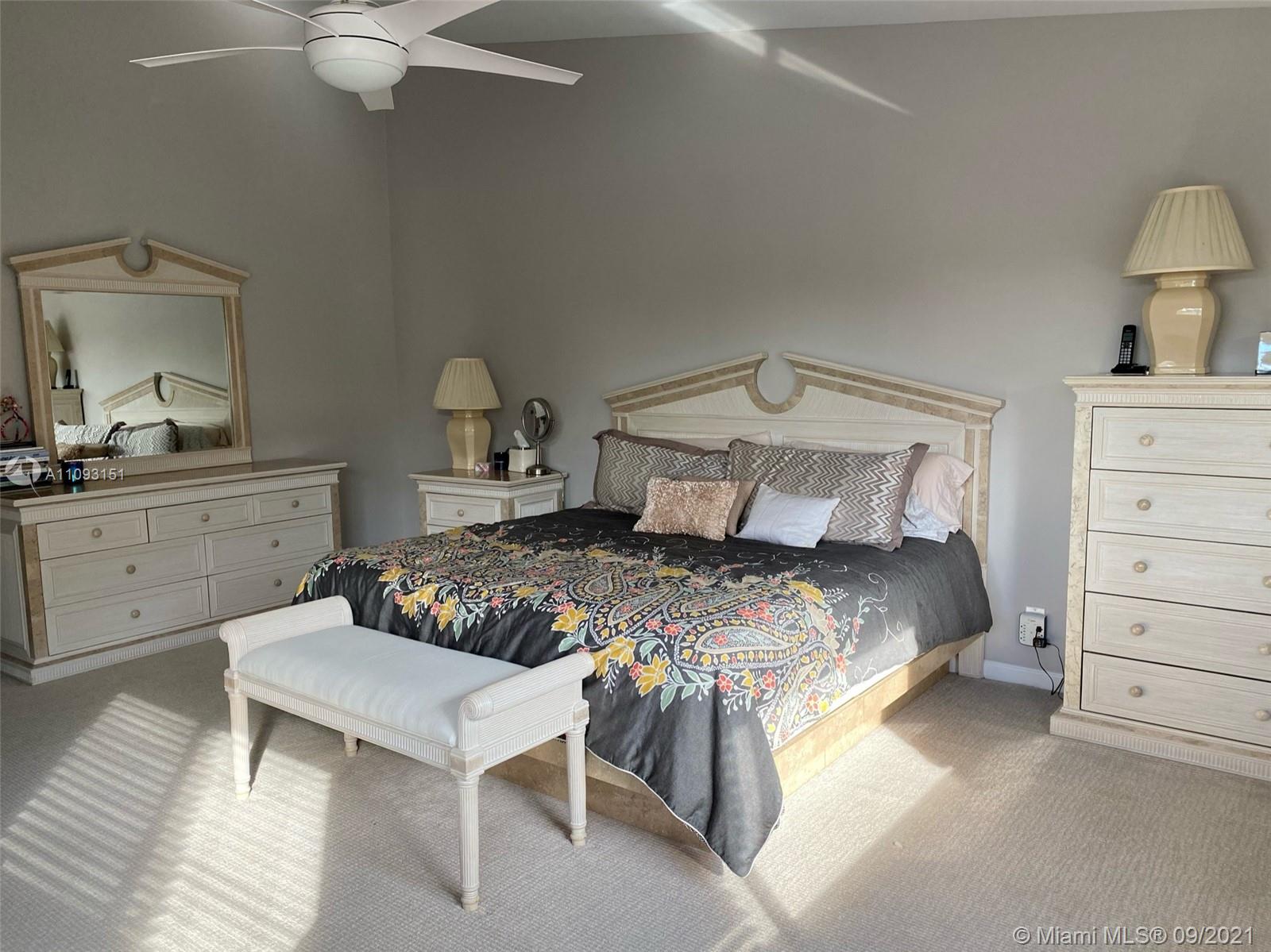 19620 Planters Point Drive Boca Raton, FL 33434 - Photo 18 of 21 a bedroom with a bed and a chandelier