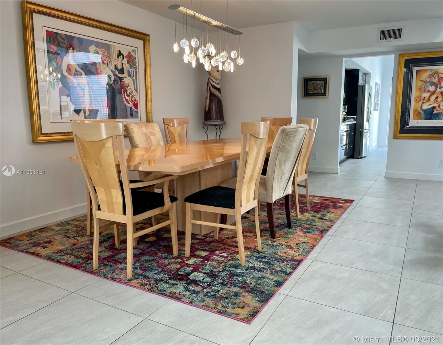 19620 Planters Point Drive Boca Raton, FL 33434 - Photo 4 of 21 a view of a dining room with furniture a chandelier and wooden floor