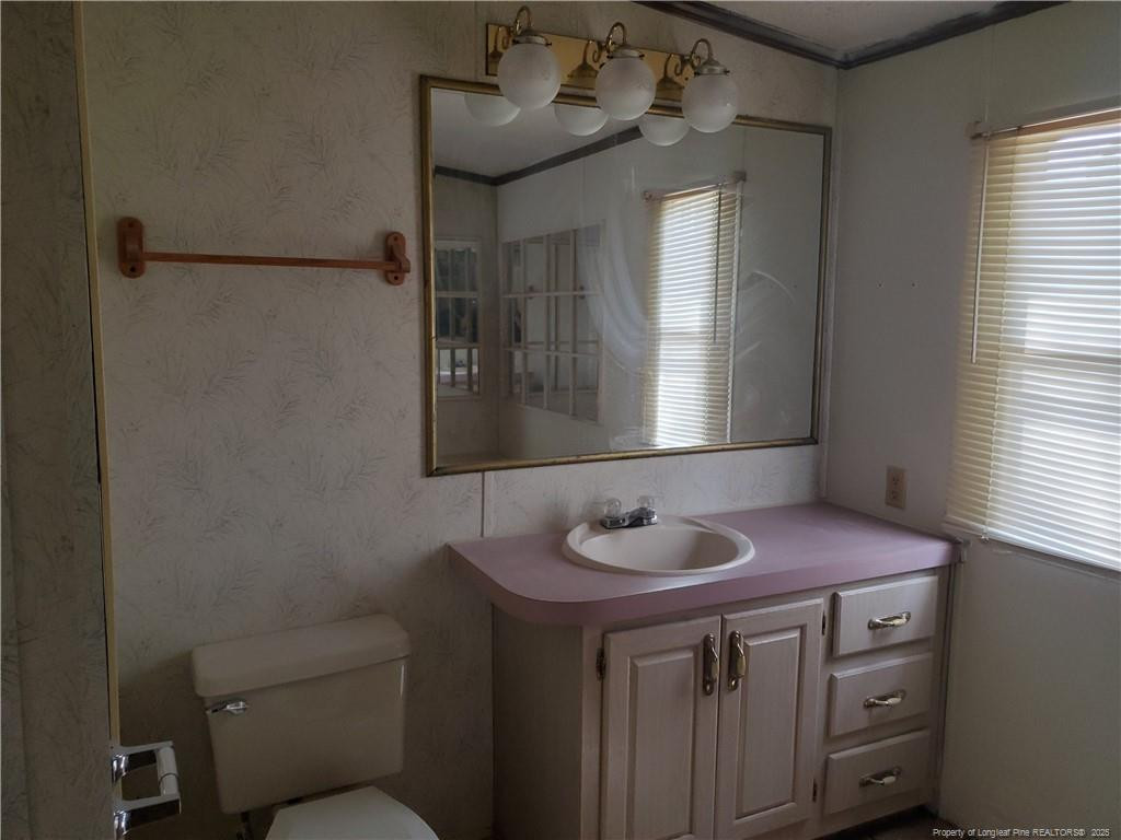 50 Old Forte Trail Spring Lake, NC 28390 - Photo 16 of 20 a bathroom with a sink and a mirror