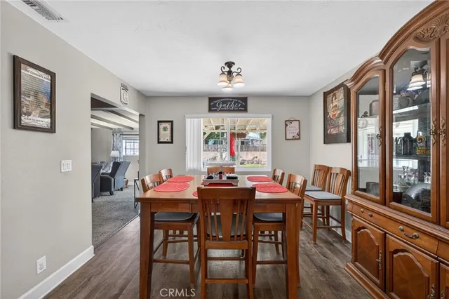a view of a dining room with furniture large window and wooden floor