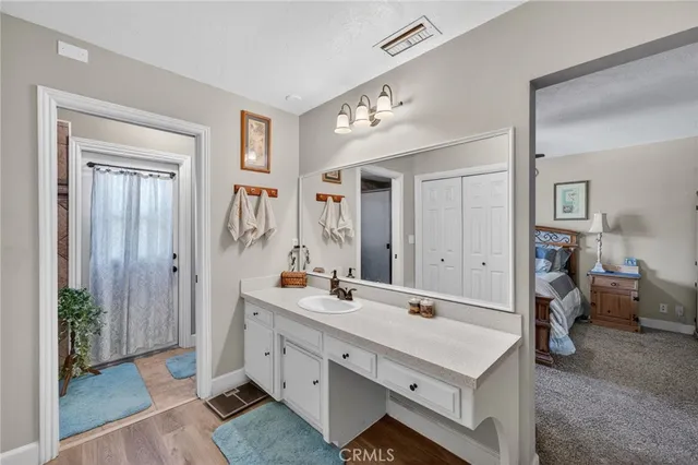 a spacious bathroom with a double vanity sink and a mirror