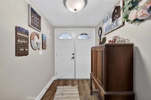 a view of an entryway with wooden floor