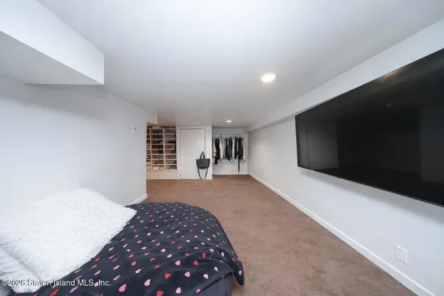 a bedroom with bed and window