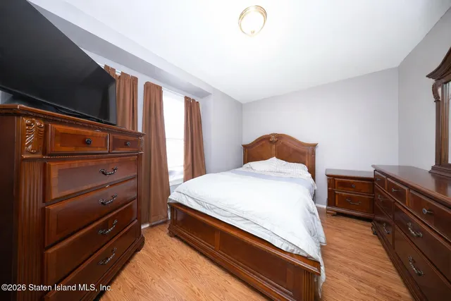 a bedroom with a bed and a dresser