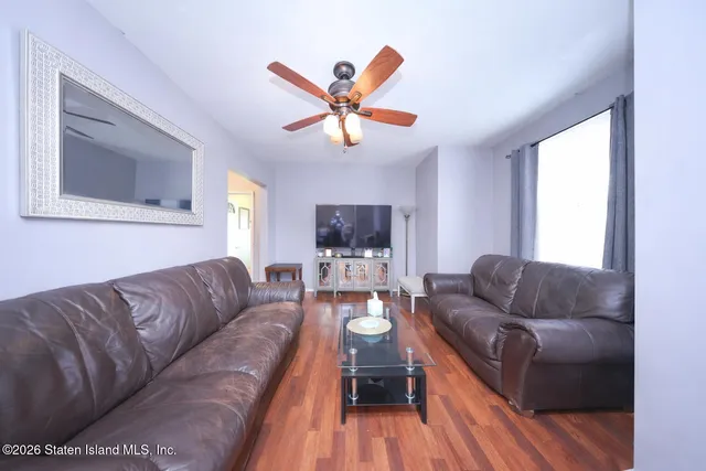 a living room with furniture and a wooden floor