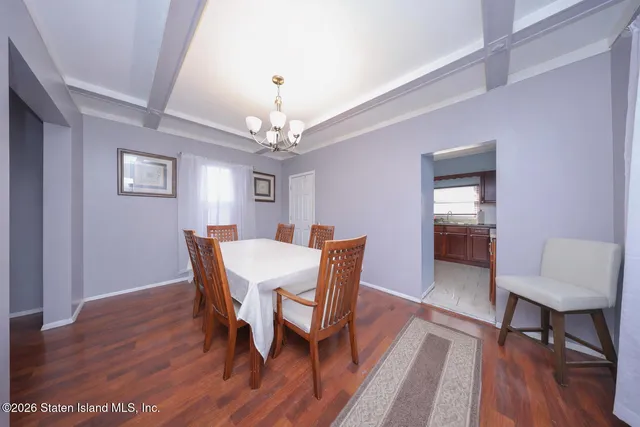 a view of a dining room with furniture wooden floor and a chandelier