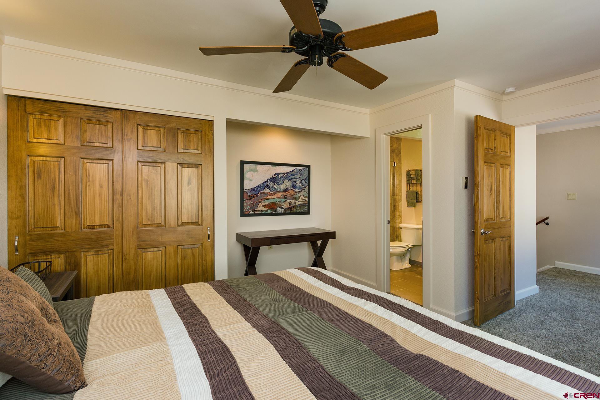 460 Sheol Street, Unit 17 Durango, CO 81301 - Photo 15 of 29 a bedroom with a bed and a chandelier