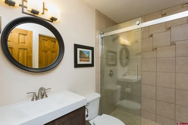 a bathroom with a toilet a sink and a mirror