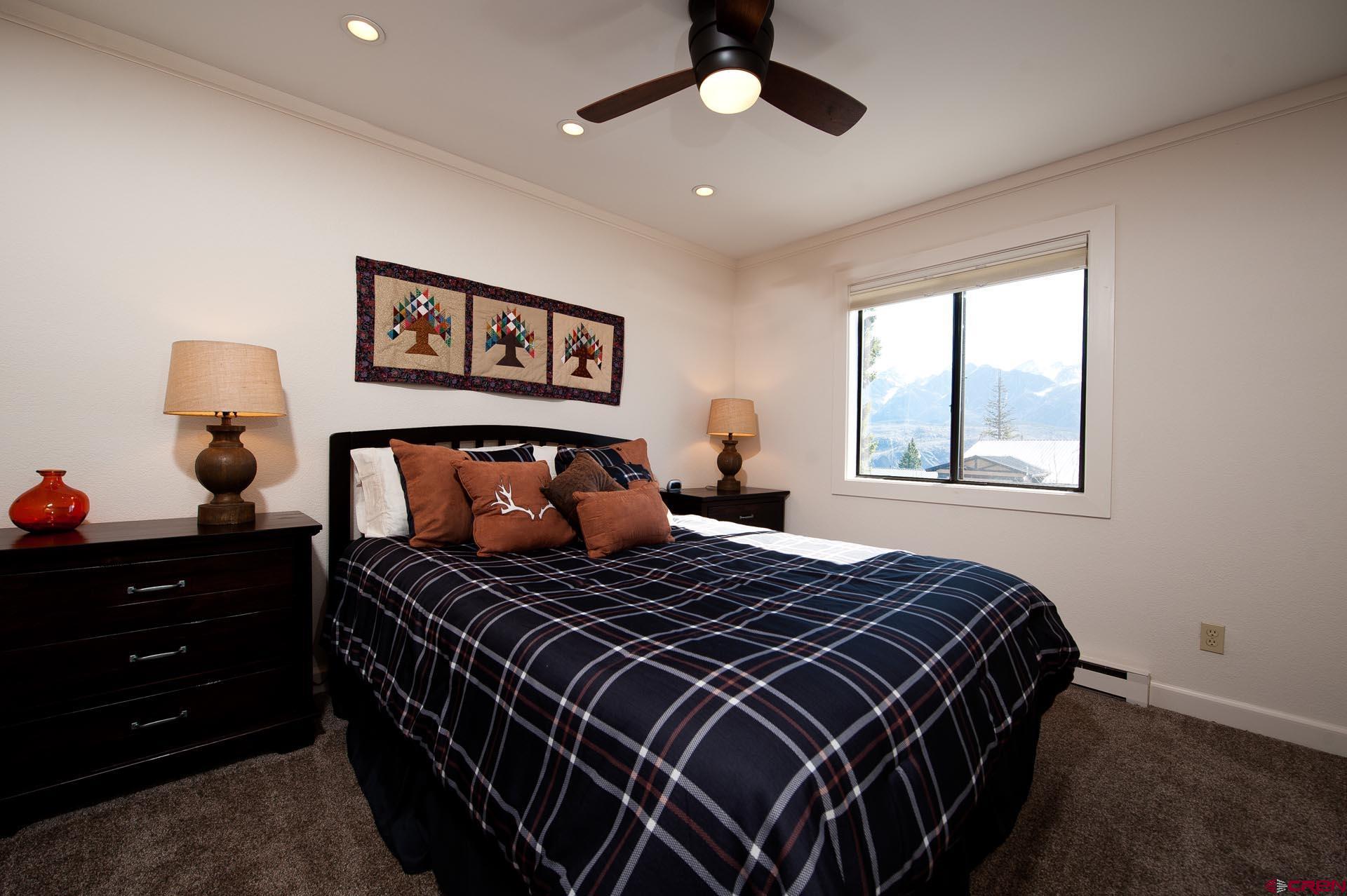 460 Sheol Street, Unit 17 Durango, CO 81301 - Photo 17 of 29 a bedroom with a bed and wooden floor