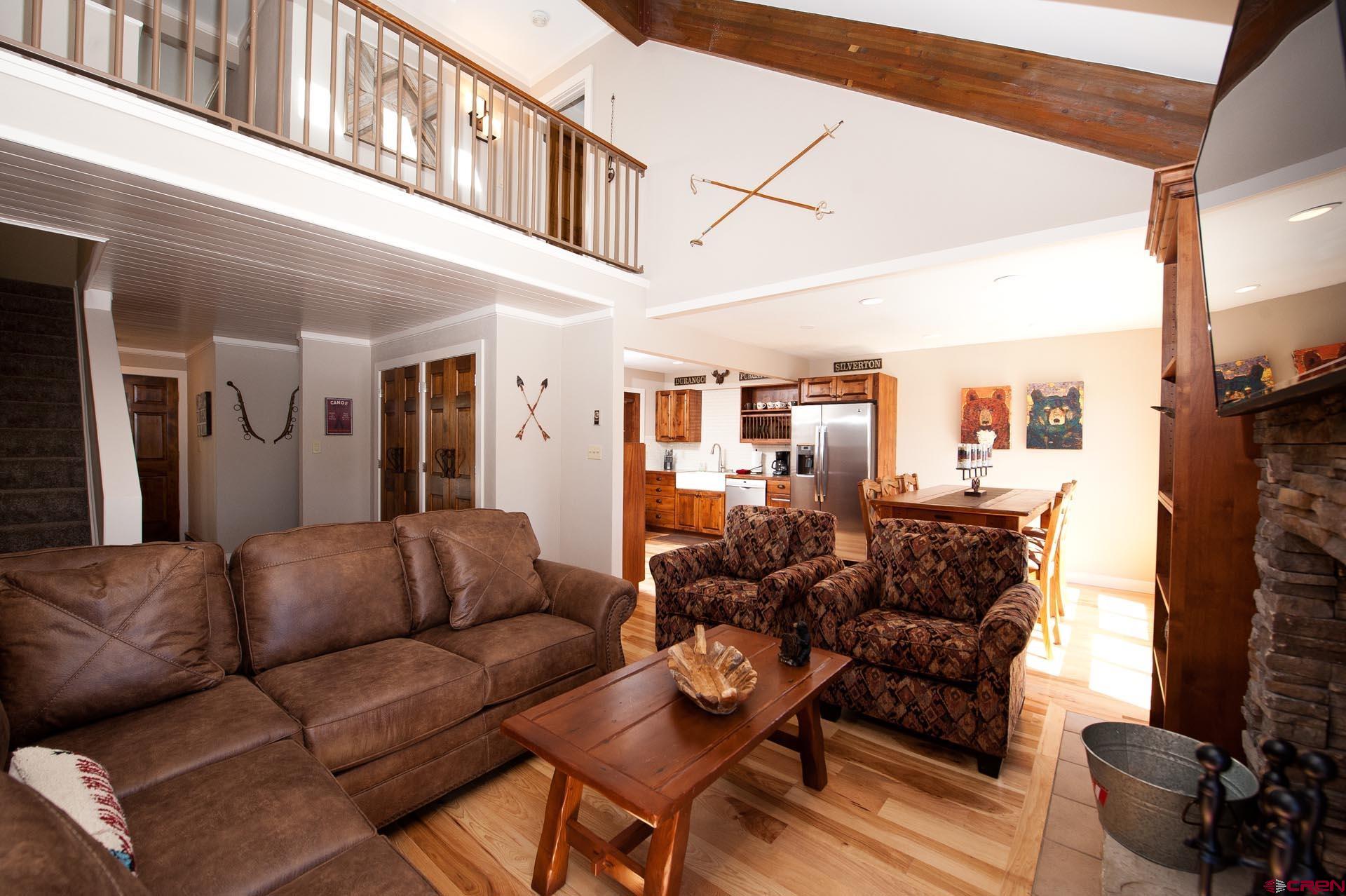 460 Sheol Street, Unit 17 Durango, CO 81301 - Photo 7 of 29 a living room with furniture a fireplace and a large window