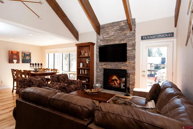 a living room with furniture fireplace and flat screen tv