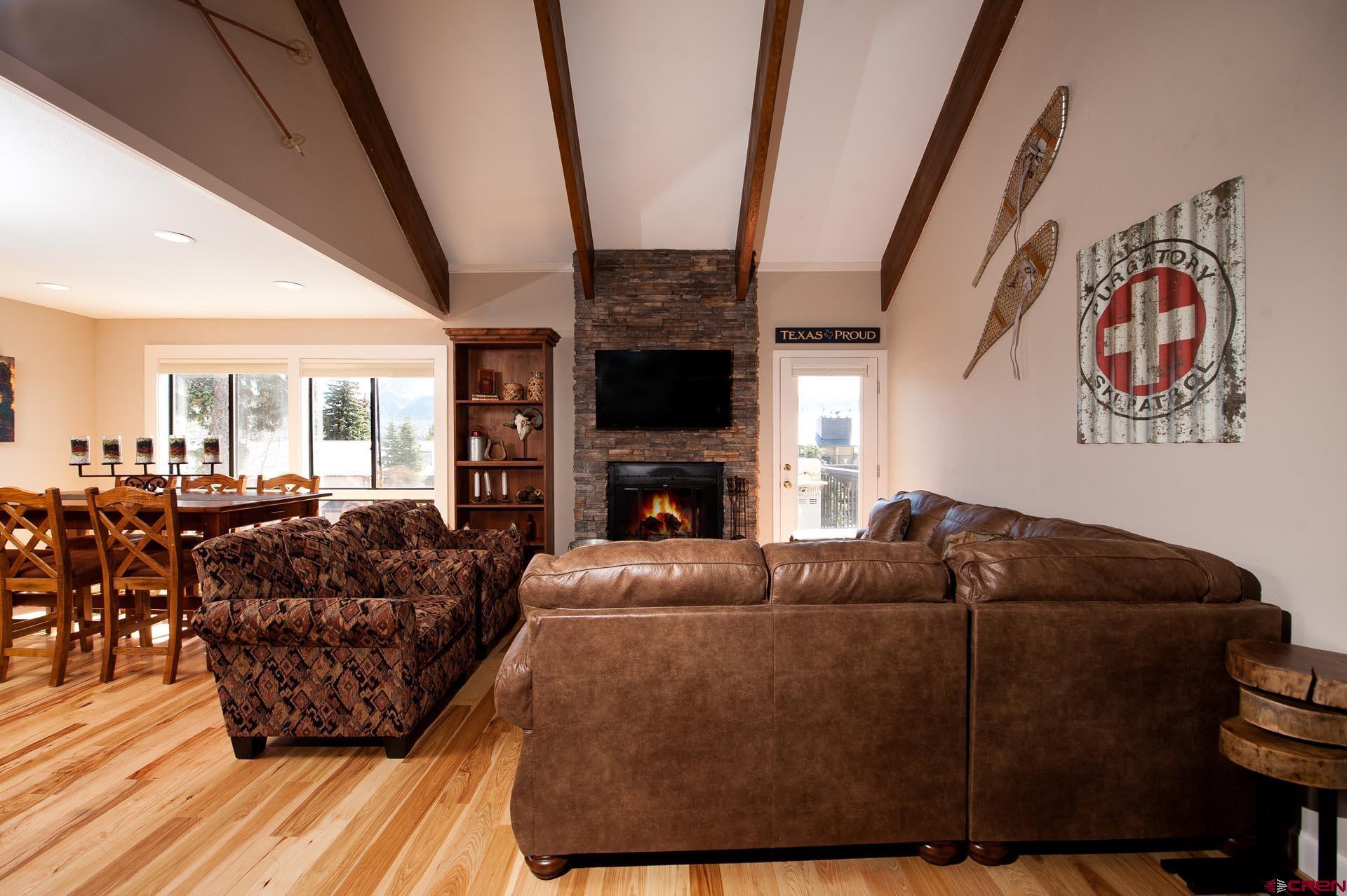 460 Sheol Street, Unit 17 Durango, CO 81301 - Photo 10 of 29 a living room with furniture a fireplace and a flat screen tv