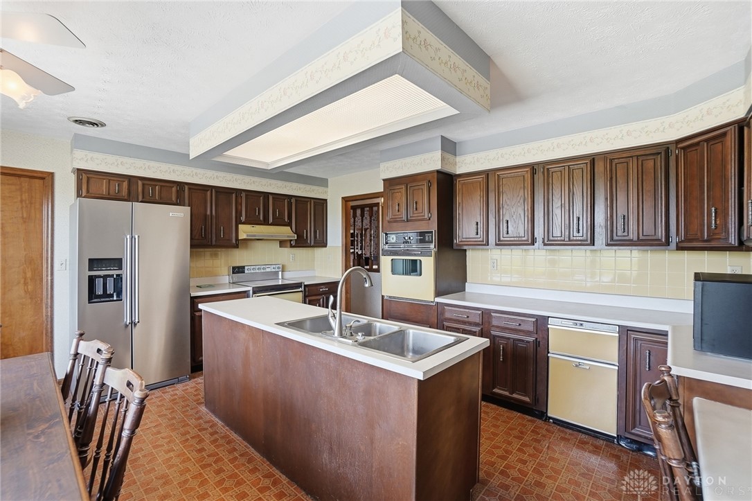 5669 O Neall Road Waynesville, OH 45068 - Photo 24 of 72 This spacious kitchen offers ample cabinetry, modern appliances, and a convenient island with a sink.
