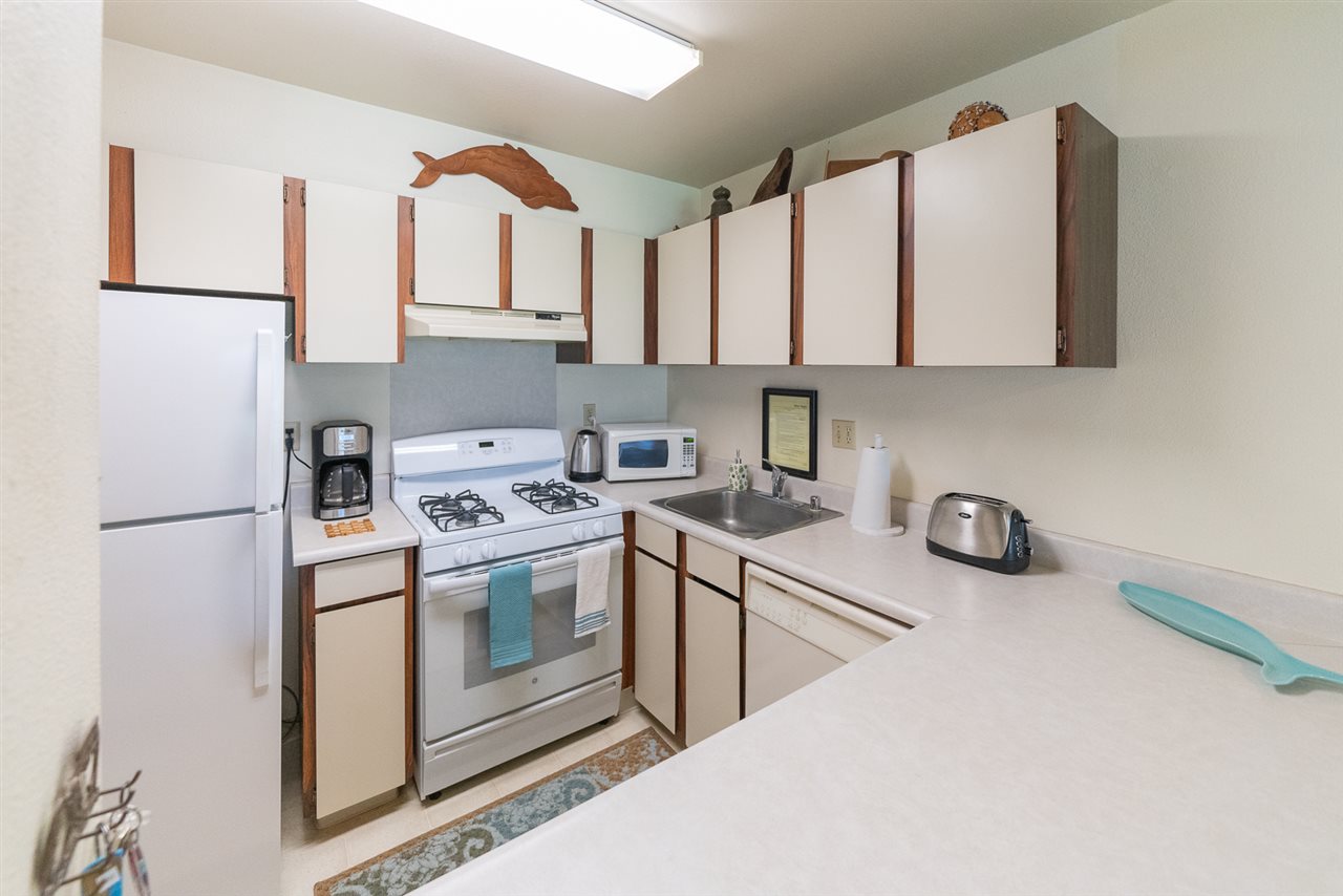 2531 South Kihei Road, Unit DG06 Kihei, HI 96753 - Photo 14 of 16 a kitchen with stainless steel appliances a stove a sink and a refrigerator