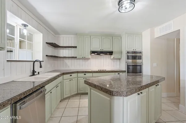 a view of a livingroom with wooden floor and a ceiling fan