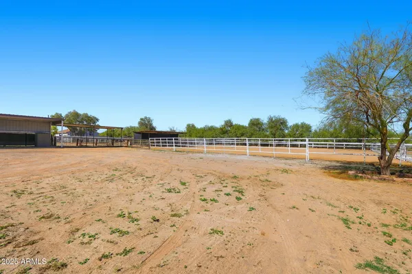a picture of a room with a white wall and white refrigerator