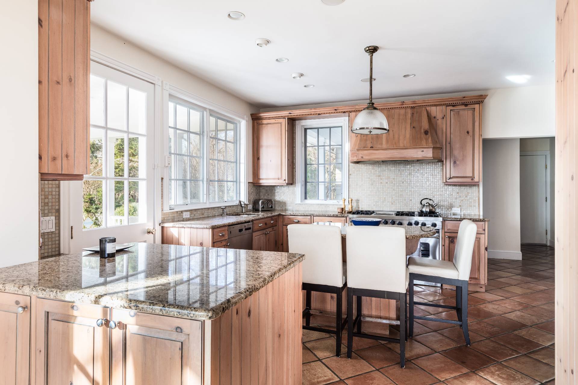 5 Mill Path Bridgehampton, NY 11963 - Photo 19 of 30 a kitchen with granite countertop a sink and white appliances