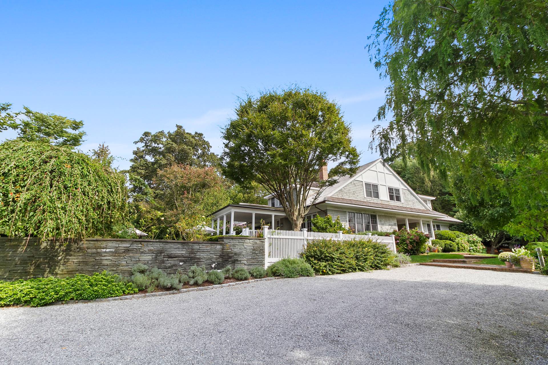 5 Mill Path Bridgehampton, NY 11963 - Photo 28 of 30 a front view of a house with a yard and garage