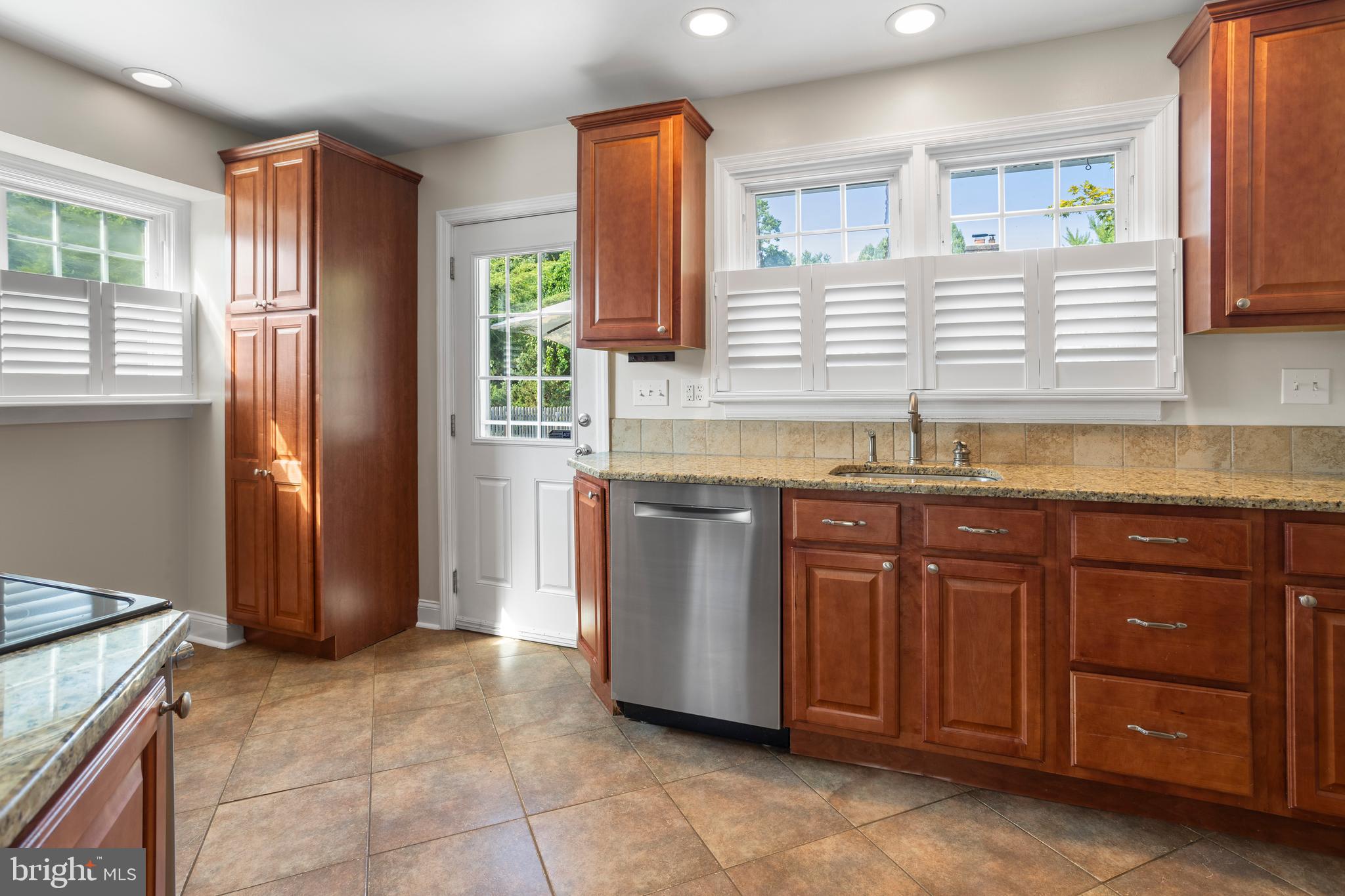 100 Shelburne Road Springfield, PA 19064 - Photo 11 of 31 a kitchen with stainless steel appliances granite countertop a sink and a stove