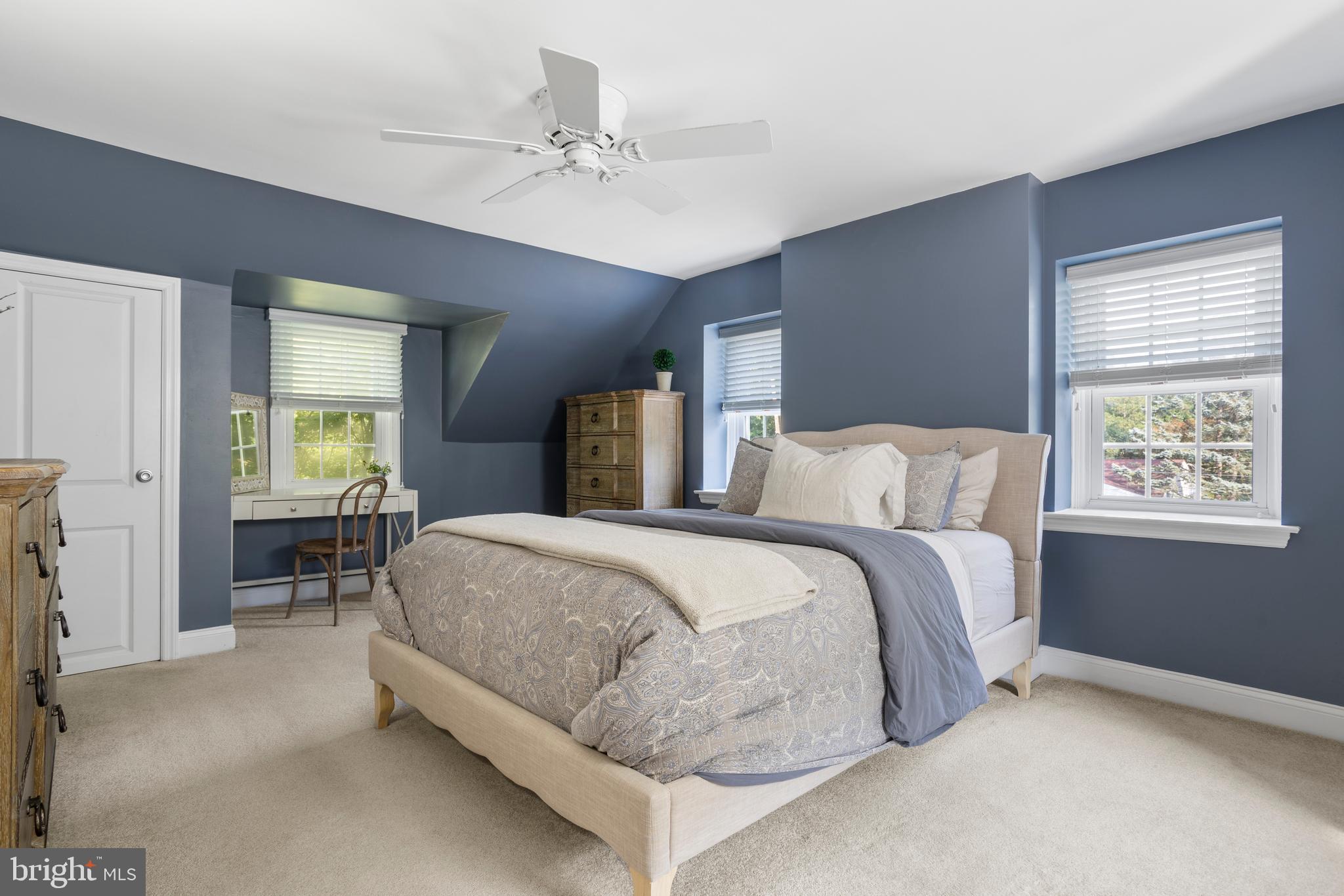 100 Shelburne Road Springfield, PA 19064 - Photo 14 of 31 a spacious bedroom with a bed and a chandelier