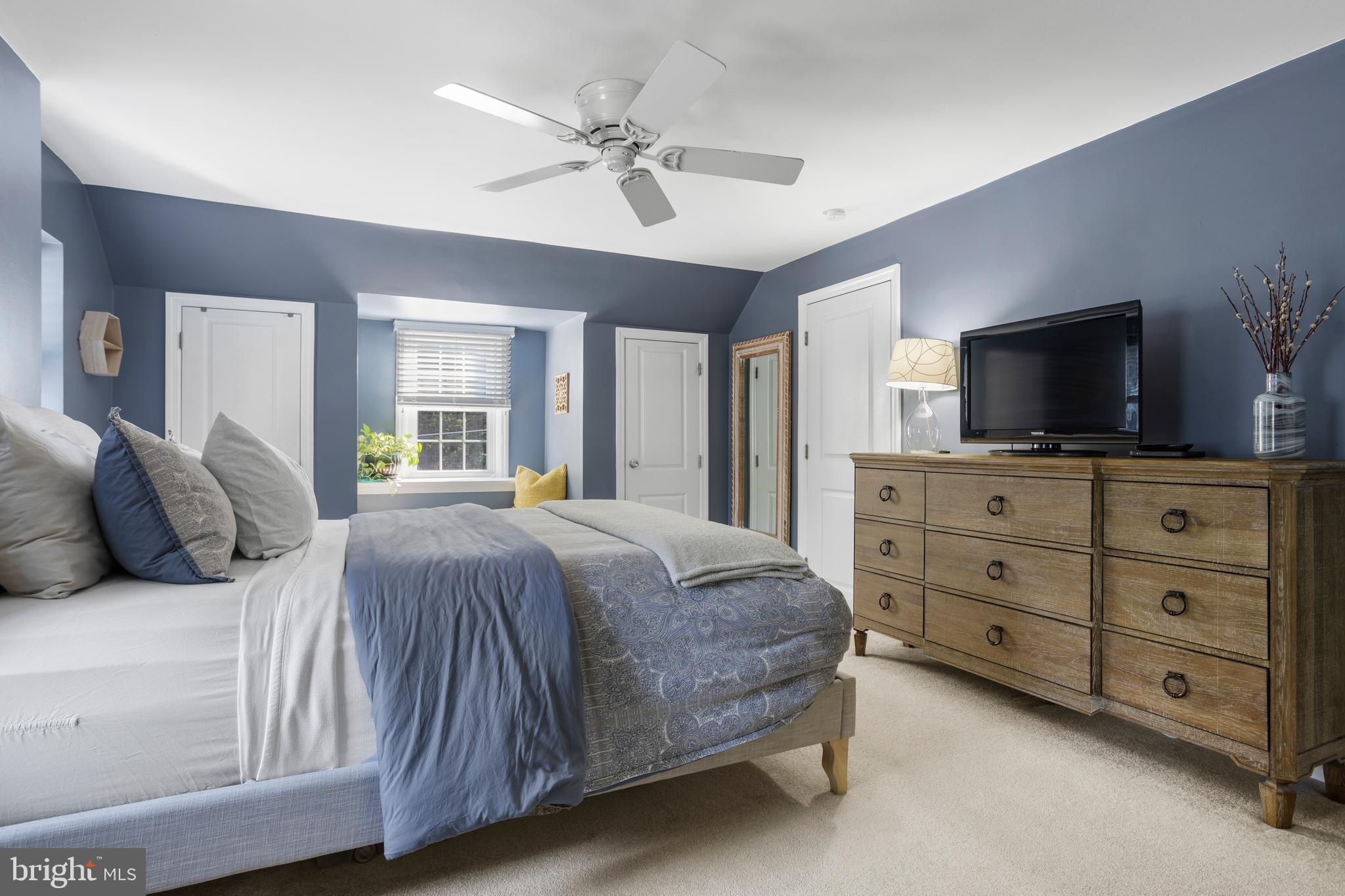 100 Shelburne Road Springfield, PA 19064 - Photo 15 of 31 a bedroom with a large bed and a flat tv screen on dresser