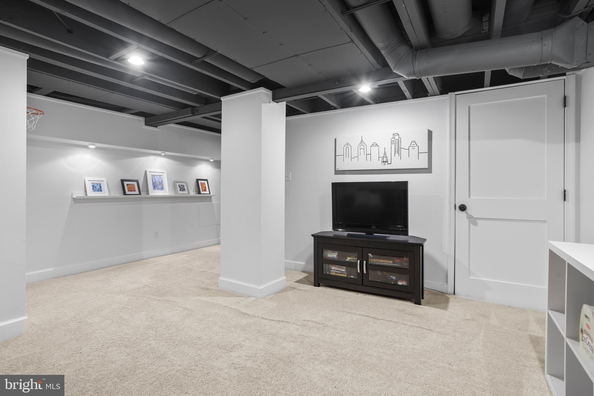 100 Shelburne Road Springfield, PA 19064 - Photo 22 of 31 a room with furniture and flat screen tv