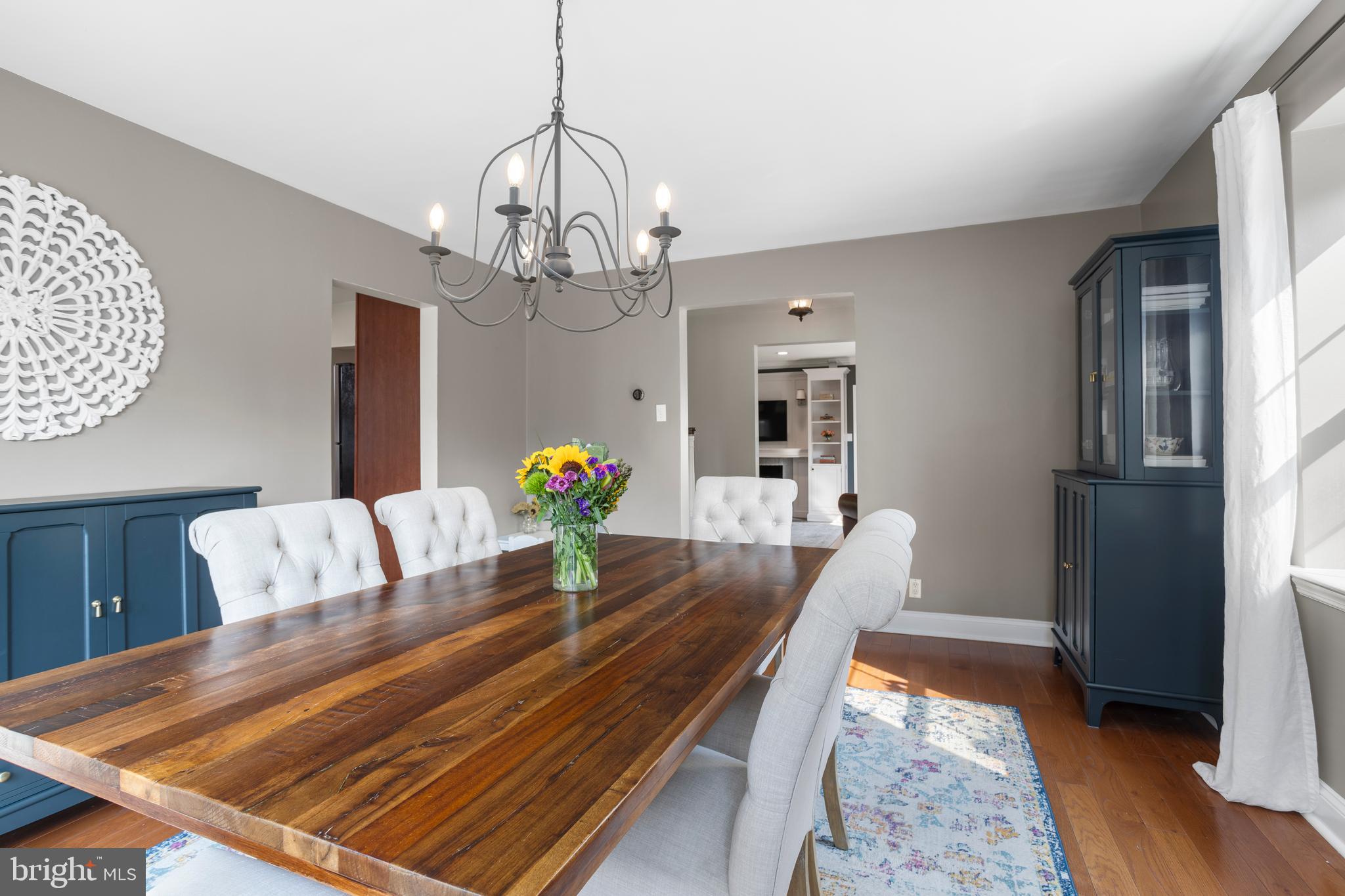 100 Shelburne Road Springfield, PA 19064 - Photo 7 of 31 a living room with dining table furniture and a chandelier