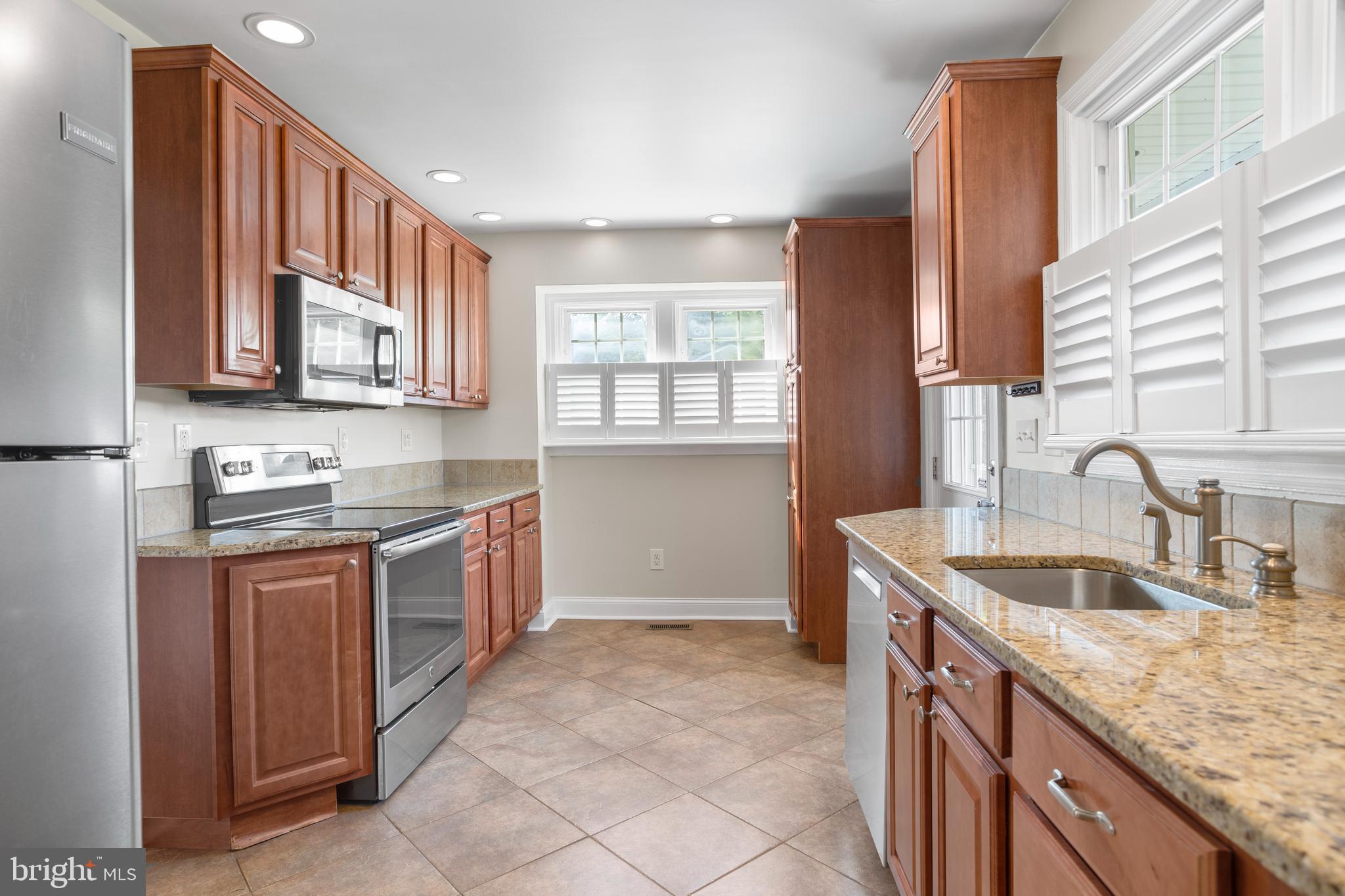 100 Shelburne Road Springfield, PA 19064 - Photo 10 of 31 a kitchen with stainless steel appliances granite countertop a sink stove and cabinets