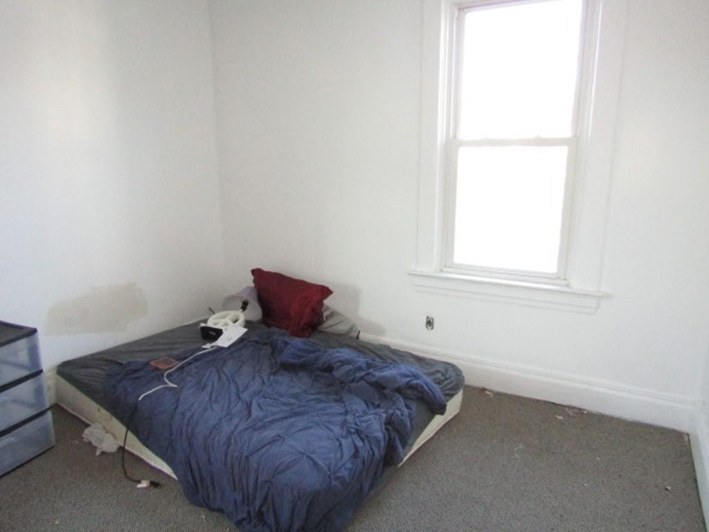501 9th Street Freedom, PA 15042 - Photo 16 of 25 a large bed sitting in a bedroom next to a window