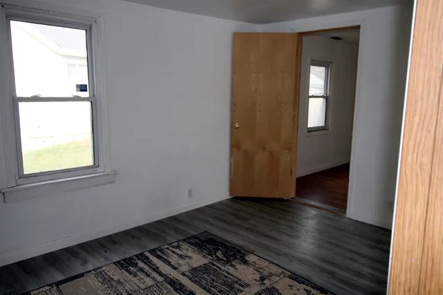 a view of an empty room and wooden floor