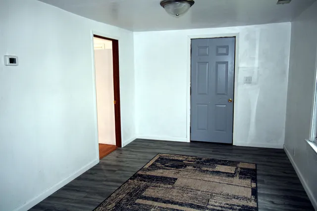 a view of a livingroom with wooden floor and carpet