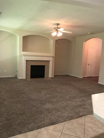 a view of an empty room with a fireplace