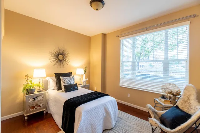 a living room with furniture and a view of kitchen