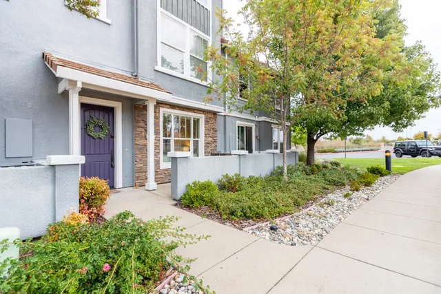 a front view of a house with a garden