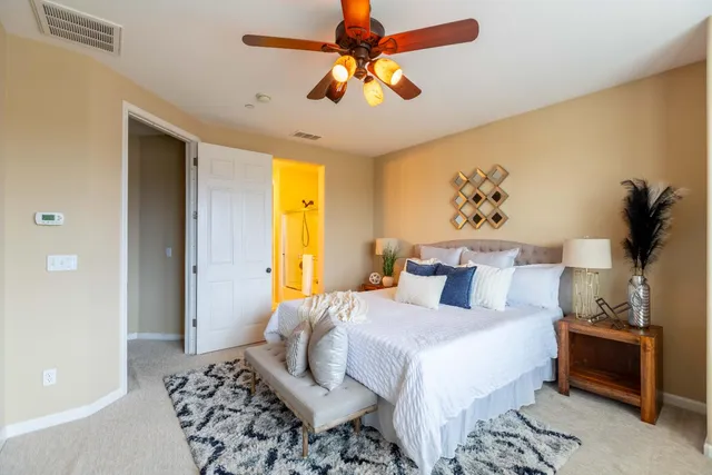 a bedroom with a bed and ceiling fan
