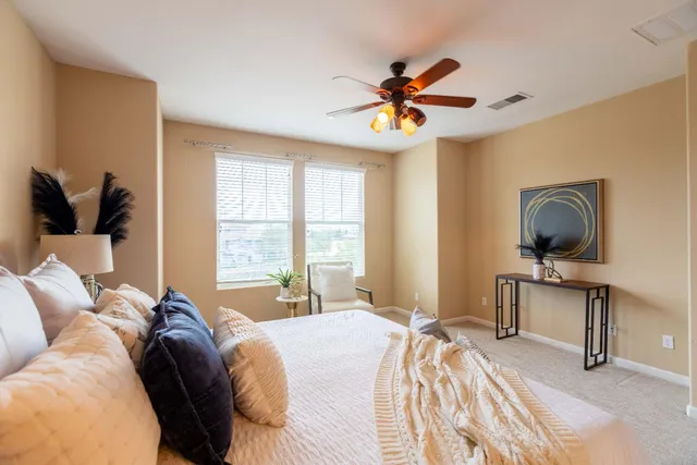 a bathroom with a sink a toilet a mirror and shower