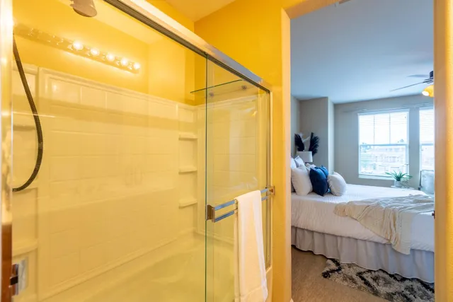 a bedroom with a bed and a potted plant