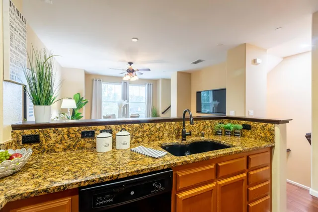 a living room with furniture and kitchen view