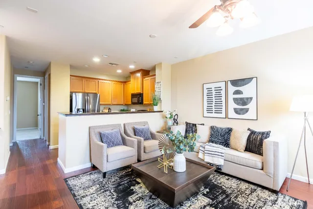 a kitchen with stainless steel appliances granite countertop a refrigerator stove and sink