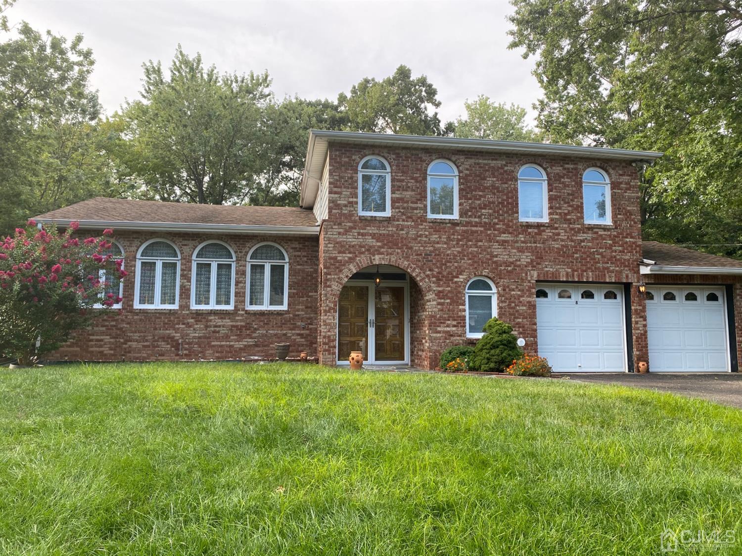 8 Devon Road Edison, NJ 08820 - Photo 1 of 1 a front view of a house with a garden and yard