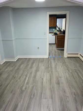 a view of kitchen with closet and wooden floor