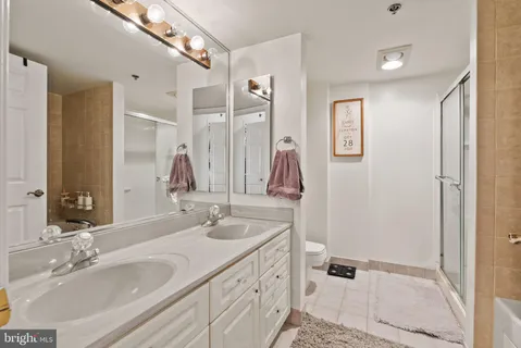 a bathroom with a double vanity sink and a mirror