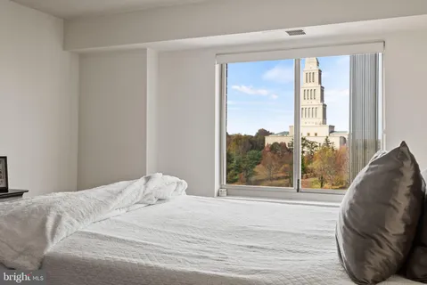 a bedroom with a bed and glass window
