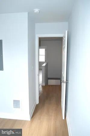 a view of a room with wooden floor