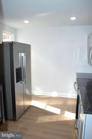 a kitchen with stainless steel appliances a stove a sink a microwave and wooden cabinets