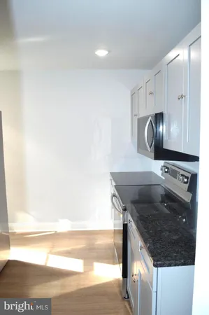 a kitchen with stainless steel appliances a stove a refrigerator and a microwave