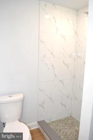 a bathroom with a sink a toilet and mirror