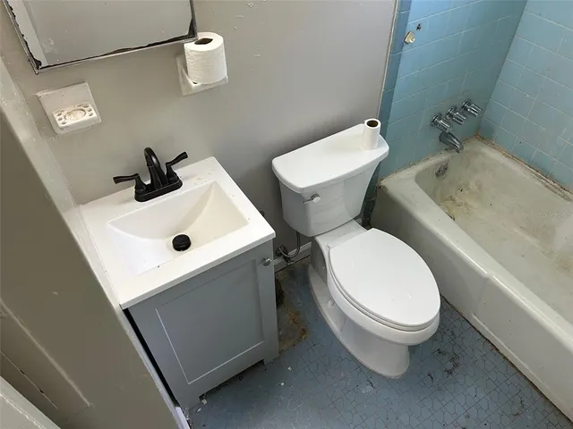 a white toilet sitting next to a bathroom sink