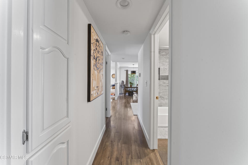 3585 Woodhaven Street Simi Valley, CA 93063 - Photo 15 of 33 a view of a hallway with wooden floor and furniture